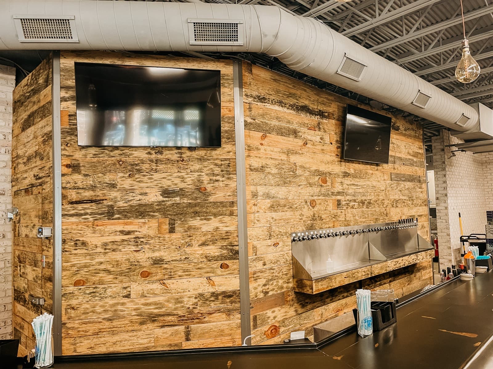 Bar area with mounted TVs and distributed audio