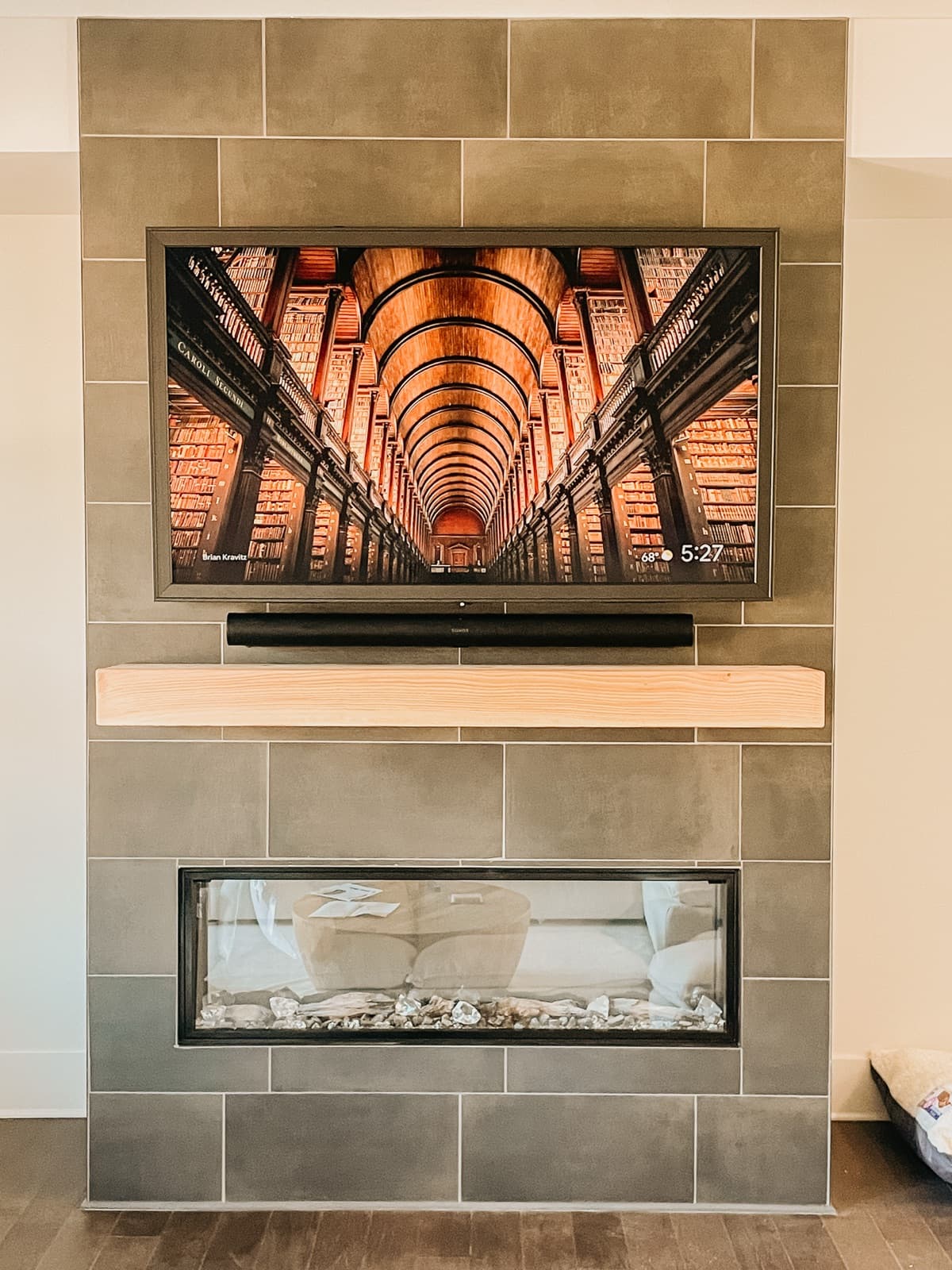 Sony TV and Sonos sound bar mounted on a tile fireplace